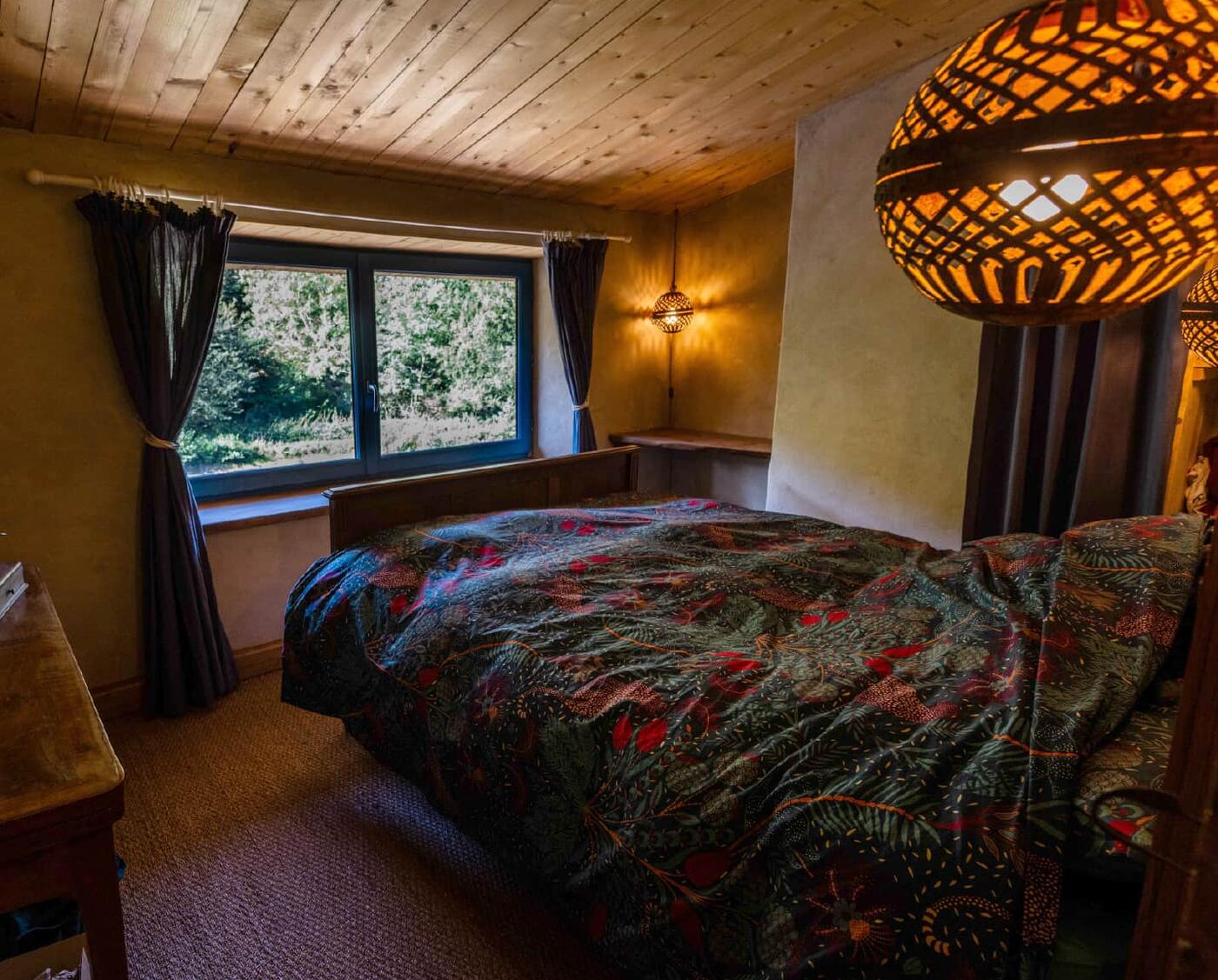 Chambre à la suspension en rotin, ouverte sur la forêt
